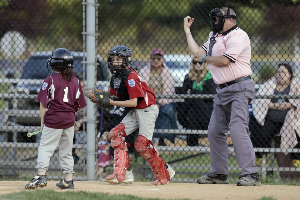 Umpire Brian Kennedy makes a call while officiating a game at the Deptford Little League complex in Deptford, N.J., on May 10, 2023. Baseball is steeped in the tradition of fans wanting to jeer the umpire. In Deptford, the fans could become the umpires if they won't follow league rules on sportsmanship. (Elizabeth Robertson/The Philadelphia Inquirer via AP)