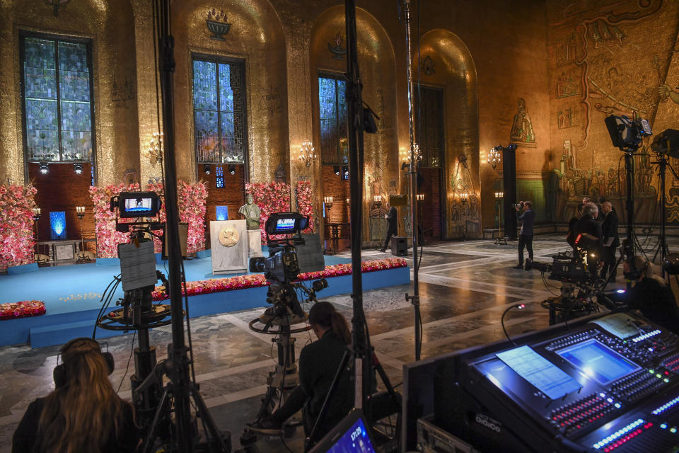 The stage is set for the socially distanced virtual Nobel Prize ceremony in the Golden Hall in the City Hall of Stockholm, Sweden, on Thursday Dec. 10, 2020. Due to the coronavirus pandemic, a digital awards ceremony takes place at the Stockholm City Hall with no laureate present, and parts of the ceremony is pre-produced. (Fredrik Sandberg / TT via AP)