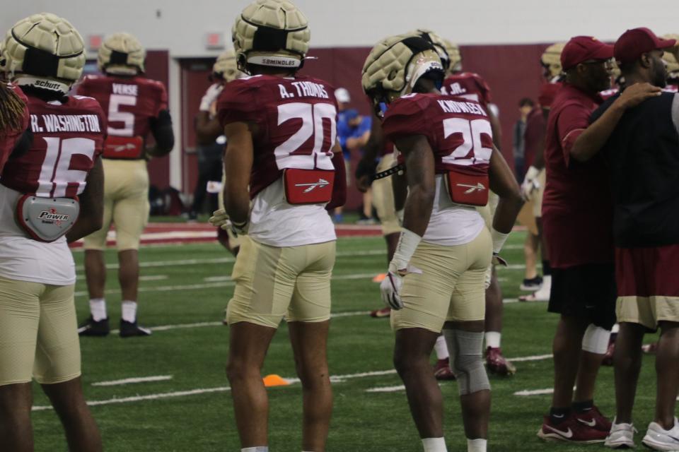 FSU defensive backs Hunter Washington, Azareye'h Thomas and Kevin Knowles II go through stretch during the Seminoles' fourth spring football practice on Friday, March 11, 2022.
