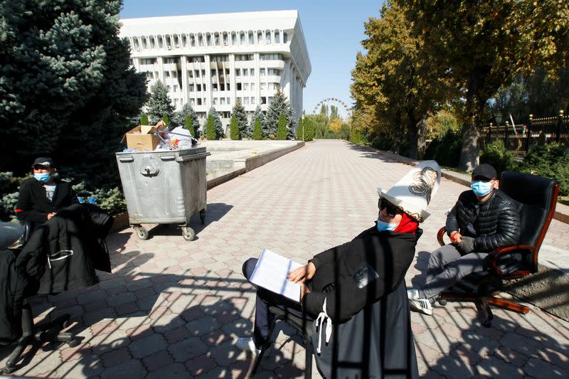 Members of voluntary people's patrol guard the government headquarters building in Bishkek