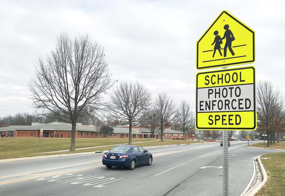This Herald-Mail file photo from December 2017 shows a sign on Yale Drive warning drivers of speed cameras. The pole-mounted cameras are on each side of Yale Drive between Eastern Elementary School, pictured, and Ruth Ann Monroe Primary School east of Hagerstown.
