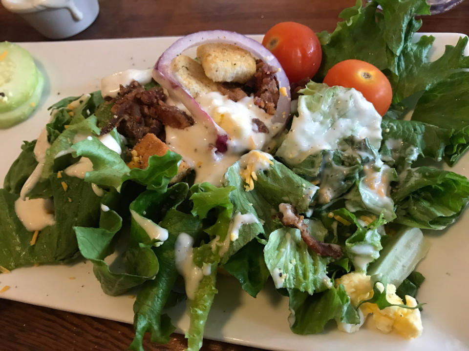 A salad with ranch dressing.