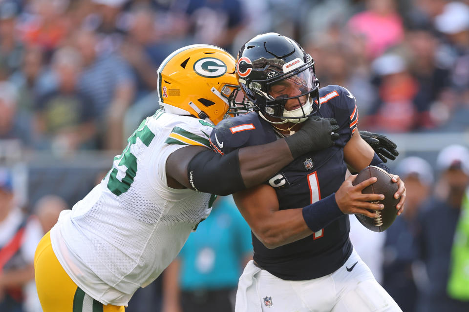 CHICAGO, ILLINOIS – SEPTEMBER 10: Justin Fields #1 of the Chicago Bears is sacked by Devonte Wyatt #95 of the Green Bay Packers during the second half at Soldier Field on September 10, 2023 in Chicago, Illinois. (Photo by Michael Reaves/Getty Images)