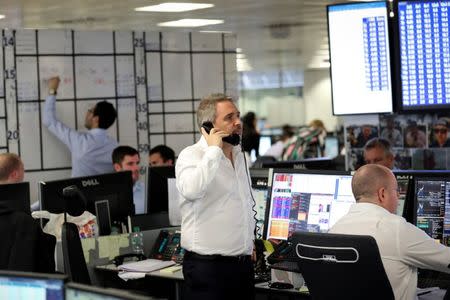 FILE PHOTO: A broker speaks on the phone on the dealing floor at ICAP in London, Britain January 3, 2018. REUTERS/Simon Dawson