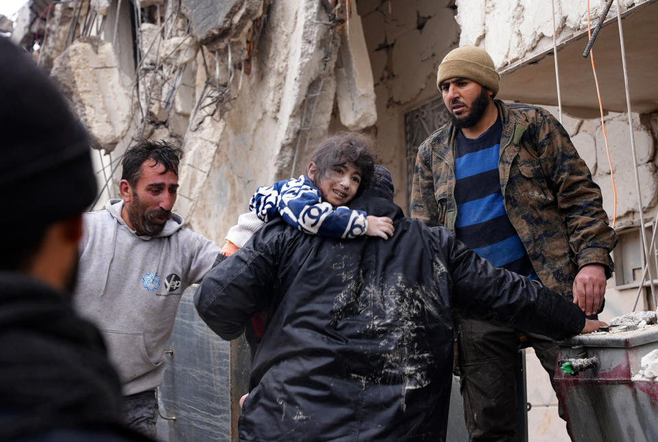Residents rescue a child from the rubble of a collapsed building following an earthquake in the town of Jandaris, Syria.<span class="copyright">Rami Al Sayed—AFP/Getty Images</span>