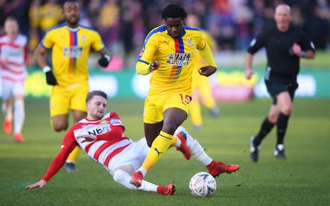 Jeffrey Schlupp of Crystal Palace evades Alfie May of Doncaster Rovers as breaks away to score his team's first goal during the FA Cup Fifth Round match - Credit: GETTY IMAGES