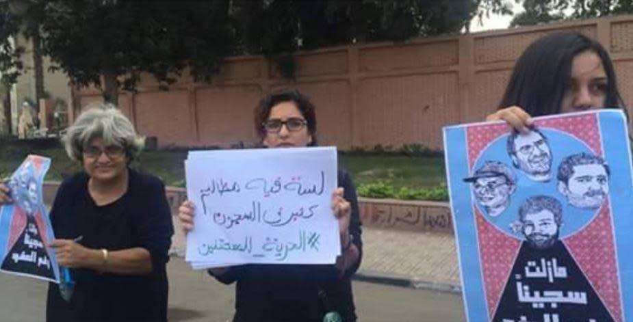 From left, Egyptian activist Alaa Abd El Fattah's mother, Dr. Leila Seif, and his two sisters Mona and Sanaa Seif, hold placards demanding the release of Alaa and other political prisoners in Cairo, Egypt.  / Credit: Facebook/Sanaa Seif