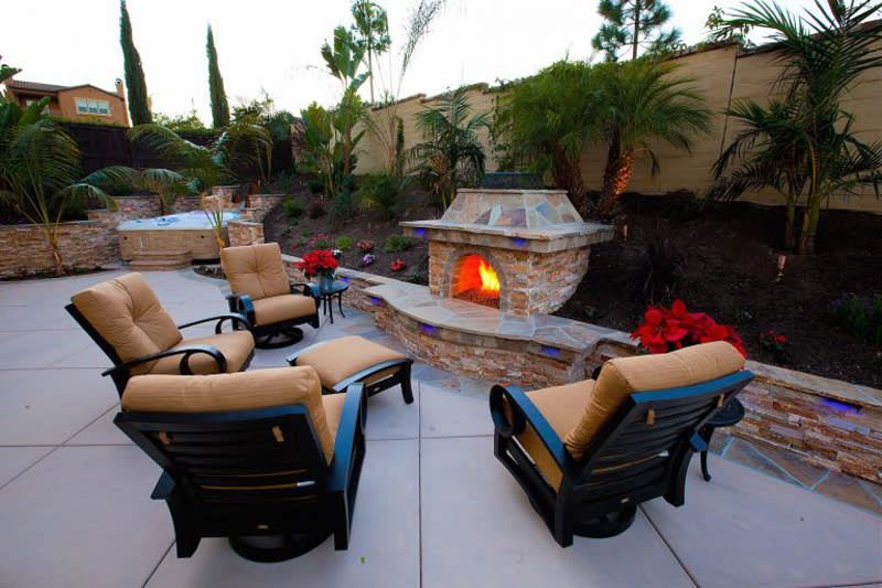 <p>Even in warm climates, a fire pit creates a glowing ambience that can't be beat. Offset your fire with colored landscaping lights to create dramatic mood lighting.</p>