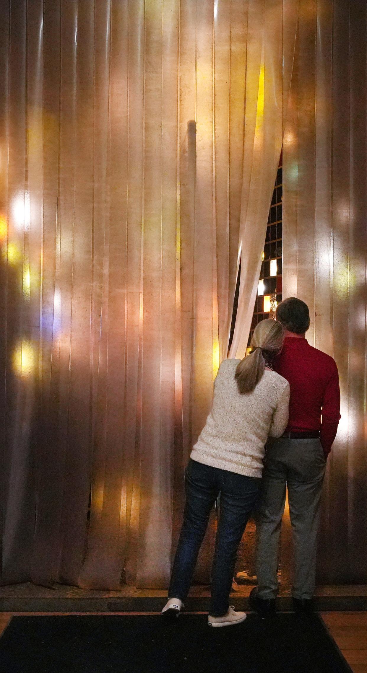 Dean and Judy Ludwig of Toledo, peer into a work titled STOCKROOM Ezekiel at the Columbus Museum of Art on Thursday, March 31, 2022.