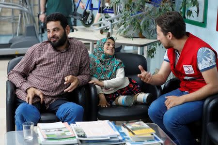 Maya Meri, 8, waits with her father Muhammed Ali Meri at a prosthetic center in Istanbul, Turkey, July 5, 2018. Picture taken July 5, 2018. REUTERS/Osman Orsal