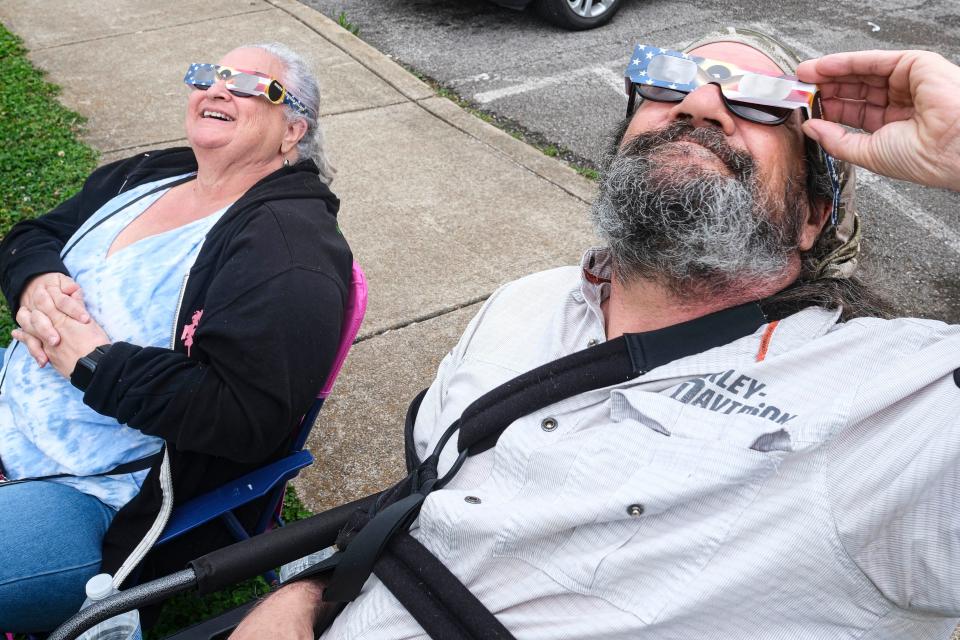 Glenna Hornady and Dan Aresenault take a look at the eclipse at Riverwalk Park in Columbia, TN on April 8, 2024.