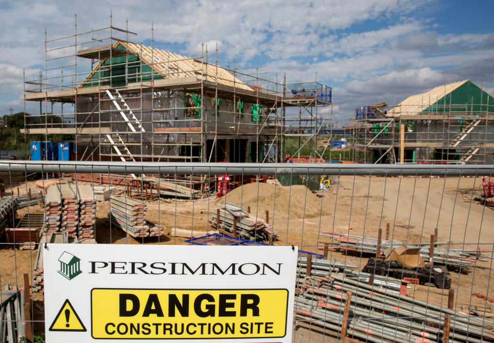 A warning sign is displayed at a Persimmon construction site in Dartford, Britain August 21, 2015. REUTERS/Neil Hall/File Photo