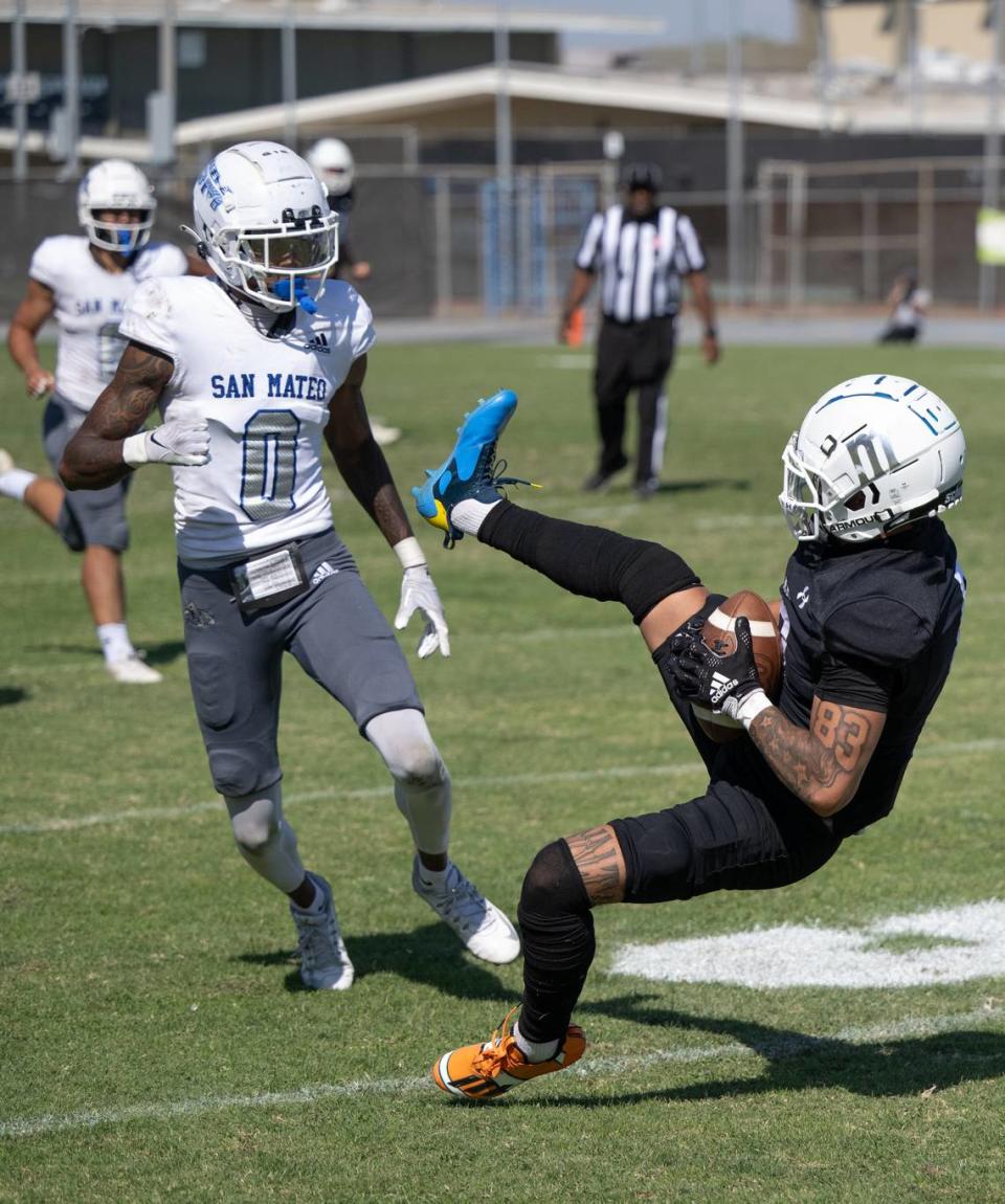 Modesto’s Bronson England falls backward while making a catch during the game with San Mateo at Modesto Junior College in Modesto, Calif., Saturday, Sept. 16, 2023.