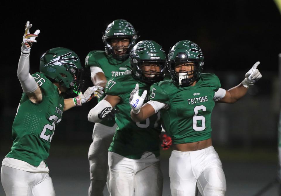 Pacifica's Jamari Ransom celebrates with his teammates after returning an interception of a Rio Mesa pass for a touchdown during the fourth quarter of their CIF-SS Division 4 first-round playoff game at Pacifica High on Friday, Nov. 4, 2022. Pacifica won 34-7.