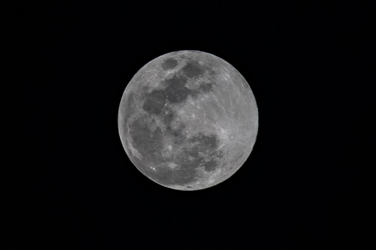The last full moon of the year, also known as a cold moon, is seen over the sky of Caracas, on Dec. 7, 2022.