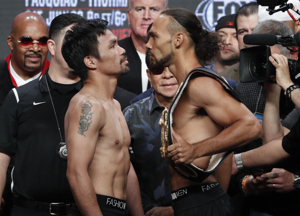 Manny Pacquiao, front left, and Keith Thurman pose during a weigh-in Friday, July 19, 2019, in Las Vegas. They are scheduled to fight in a welterweight championship boxing match Saturday in Las Vegas. (AP Photo/John Locher)