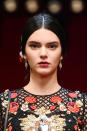 <p>At Dolce & Gabbana Spring 2015 in Milan, Jenner channeled Spanish bullfighters with cherry red lips and a tight centerpart chignon. <i>(Photo: Getty Images)</i></p>