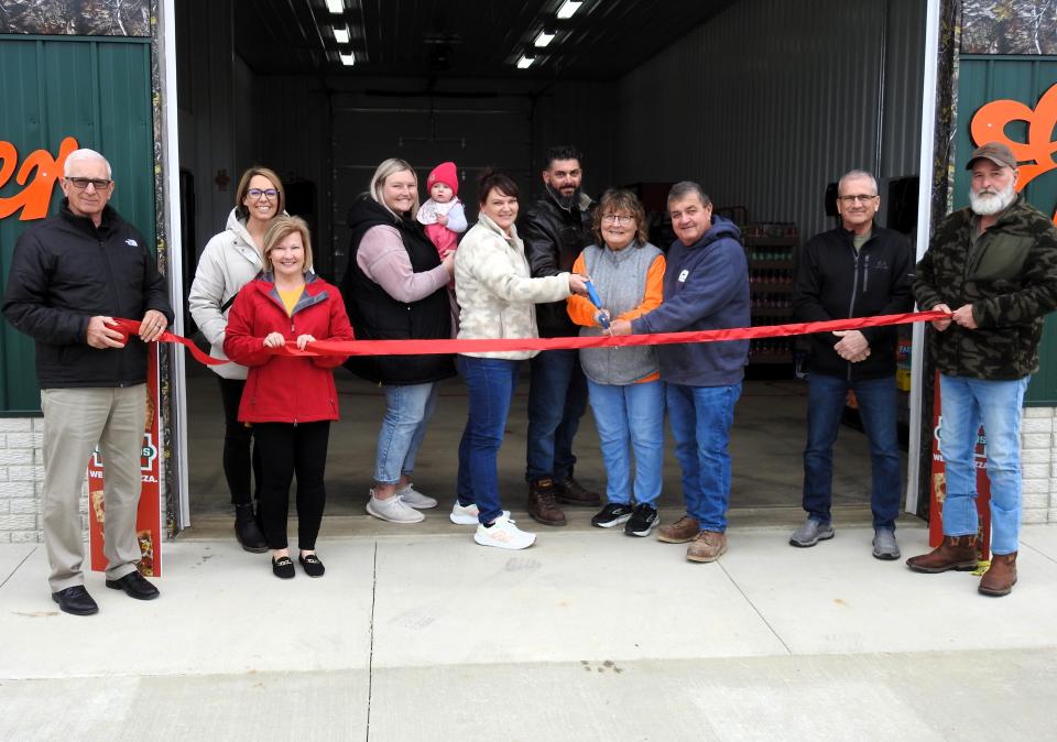 A ribbon cutting was held recently for Mossy's Corner Drive Thru and Gas Station with the Coshocton County Chamber of Commerce. Pictured are Commissioner Dane Shryock, Tiffany Swigert of the Coshocton Port Authority, Amy Crown of the Coshocton County Chamber of Commerce, Haley Journey with 7-month-old Emery Journey, Michelle and Robert Dorsey, Gloria and Michael Mosholder and Commissioners Gary Fischer and Rick Conkle.