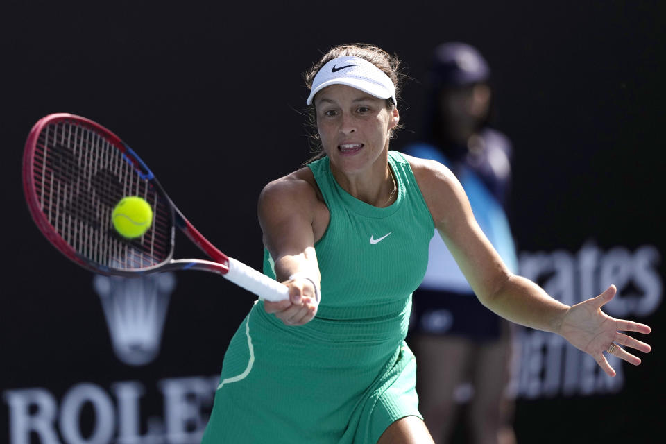 Tatjana Maria of Germany plays a forehand return to Jasmine Paolini of Italy during their second round match at the Australian Open tennis championships at Melbourne Park, Melbourne, Australia, Thursday, Jan. 18, 2024. (AP Photo/Alessandra Tarantino)