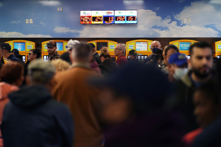 People wait in line at the Lotto Store at Primm just inside the California border Friday, Jan. 13, 2023, near Primm, Nev. Mega Millions players will have another chance Friday night to end months of losing and finally win a jackpot that has grown to $1.35 billion. (AP Photo/John Locher)