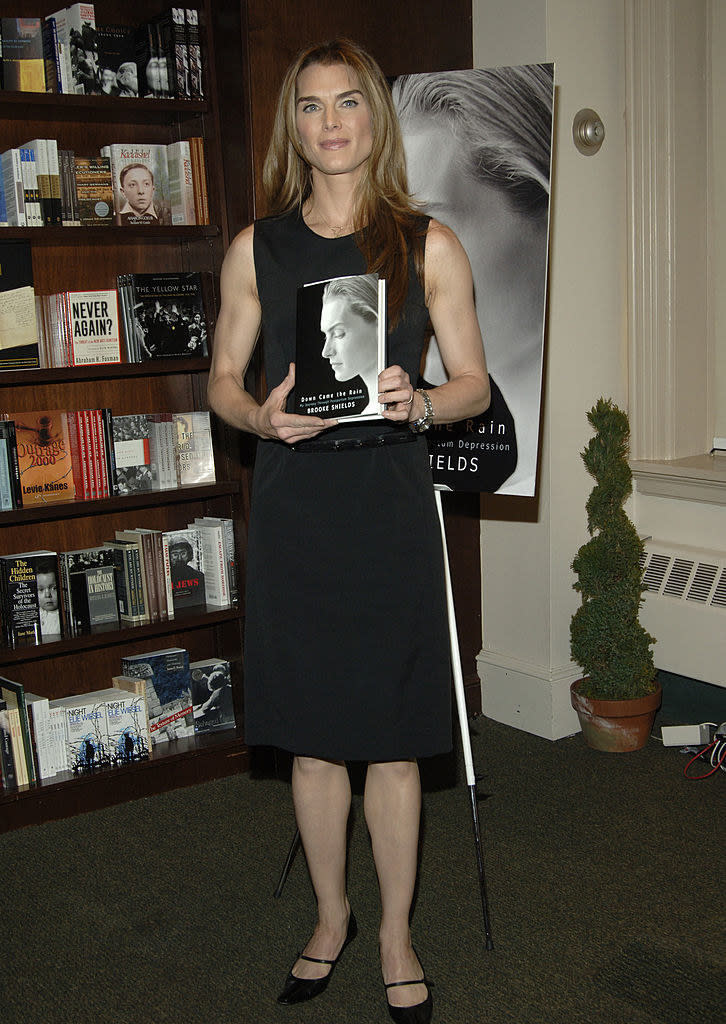 Brooke Shields holding her book