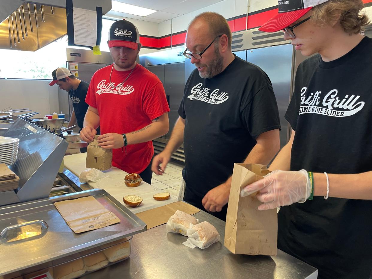 From left, cooks Jacob Finley and Jacob Loomis, business owner Joe Matley, and son Cam Matley prepare sliders at Griffs Grill in Howell on Thursday, July 27, 2023.