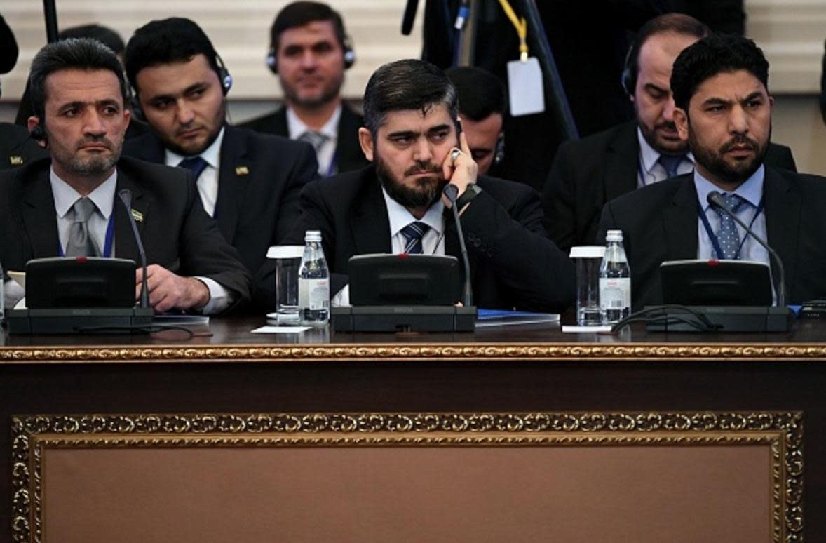 Chief opposition negotiator Mohammad Alloush (C) of the Jaish al-Islam (Army of Islam) rebel group attends the first session of Syria peace talks at Astana's Rixos President Hotel on January 23, 2017: Getty