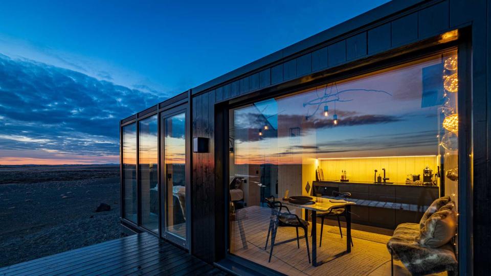 Glass house in Hella, Iceland, vast landscape views and nighttime view of Northern Lights