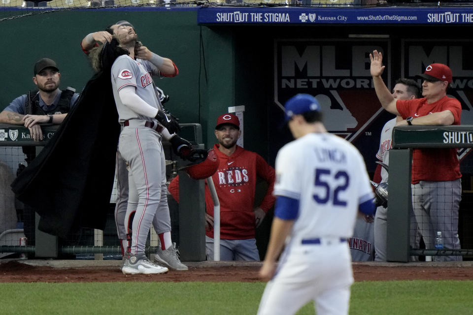 Cincinnati Reds' Jonathan India is fitted with a cape for the dugout celebration after hitting a solo home run during the fifth inning of a baseball game against the Kansas City Royals Wednesday, June 14, 2023, in Kansas City, Mo. (AP Photo/Charlie Riedel)