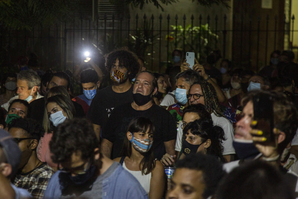 Cuban actor Jorge Perugorría, center, takes part in a demonstration to help to the dialogue between the young artists who protested in front of the doors of the Ministry of Culture and the authorities, in Havana, Cuba, Friday, Nov. 27, 2020. Dozens of Cuban artists demonstrated in front of the Ministry of Culture, protesting against the police evicting a group who participated in a hunger strike. (AP Photo/Ismael Francisco)