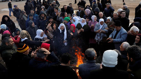 Supporters of Selahattin Demirtas, the jailed leader of the Peoples' Democratic Party (HDP), wait in front of a court house as he went on trial, 13 months after his arrest on terrorism-related charges, in Ankara, Turkey, December 7, 2017. REUTERS/Umit Bektas