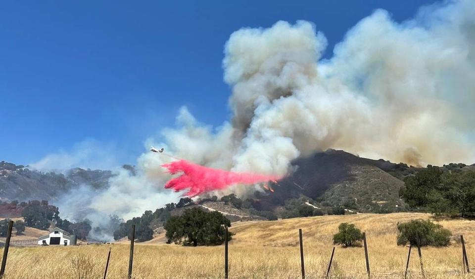 An air tanker drops retardant on the Camino Fire as it burns in the hills near Huasna on Tuesday, June 28, 2022.