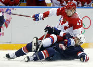 Russia forward Valeri Nichushkin collides with USA forward Max Pacioretty in the second period of a men's ice hockey game at the 2014 Winter Olympics, Saturday, Feb. 15, 2014, in Sochi, Russia. (AP Photo/Julio Cortez)