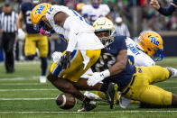 Notre Dame running back Devyn Ford (22) hits Pittsburgh defensive back M.J. Devonshire (12) as he drops a kickoff the ball during the second half of an NCAA college football game Saturday, Oct. 28, 2023, in South Bend, Ind. (AP Photo/Michael Caterina)