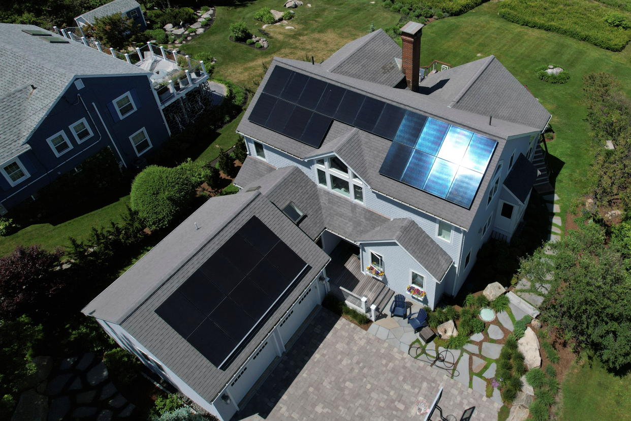 Solar panels create electricity on the roof of a house in Rockport, Mass. 