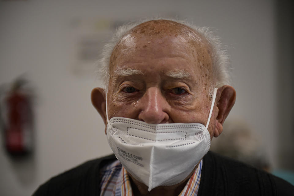 100 years old Jose Lezaun, a resident at San Jeronimo nursing home poses for a photo after receiving a third dose of the Pfizer COVID-19 vaccine, in Estella, around 38 kms from Pamplona, northern Spain, Thursday, Sept. 23. 2021. (AP Photo/Alvaro Barrientos)