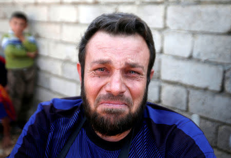Wheelchair-bound man, Abbas Ali, 42, cries with relief after escaping with his wife and four children from the Islamic State-controlled village of Abu Jarboa, Iraq October 31, 2016. REUTERS/Azad Lashkari