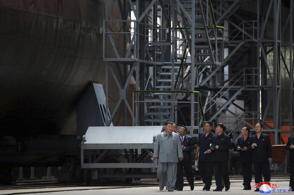 In this undated photo provided on Tuesday, July 23, 2019, by the North Korean government, North Korean leader Kim Jong Un, left, inspects a newly built submarine to be deployed soon, at an unknown location in North Korea. North Korean state media's report on Tuesday comes days after North Korea said it may lift its 20-month suspension of nuclear and missile tests to protest expected military drills between the United States and South Korea. Independent journalists were not given access to cover the event depicted in this image distributed by the North Korean government. The content of this image is as provided and cannot be independently verified. Korean language watermark on image as provided by source reads: "KCNA" which is the abbreviation for Korean Central News Agency. (Korean Central News Agency/Korea News Service via AP)