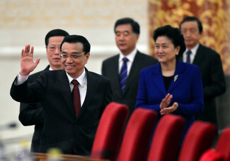 China's new Premier, Li Keqiang (2nd R), waves to journalists as he arrives together with his vice premiers, (from L) Zhang Gaoli, Wang Yang, Liu Yandong and Ma Kai, for his first press conference after the closing session of the National People's Congress, at the Great Hall of the People in Beijing, on March 17, 2013