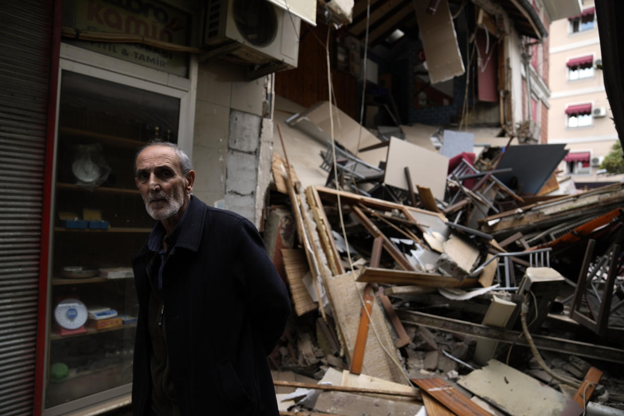 A man walks part damaged shops in Duzce, Turkey, Wednesday, Nov. 23, 2022, after a magnitude 5.9 earthquake hit a town in northwest Turkey early Wednesday, causing damage to some buildings and widespread panic. At least 68 people were injured, mostly while trying to flee homes. The earthquake was centered in the town of Golkaya, in Duzce province, some 200 kilometers (125 miles) east of Istanbul, the Disaster and Emergency Management Presidency said.(AP Photo/Khalil Hamra)