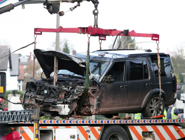 The mangled Land Rover is taken away from the scene (SWNS)