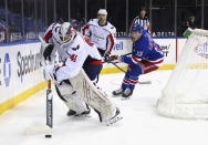 Washington Capitals' Vitek Vanecek looks to clear the puck from behind the net during the second period against the New York Rangers in an NHL hockey game Wednesday, May 5, 2021, in New York. (Bruce Bennett/Pool Photo via AP)