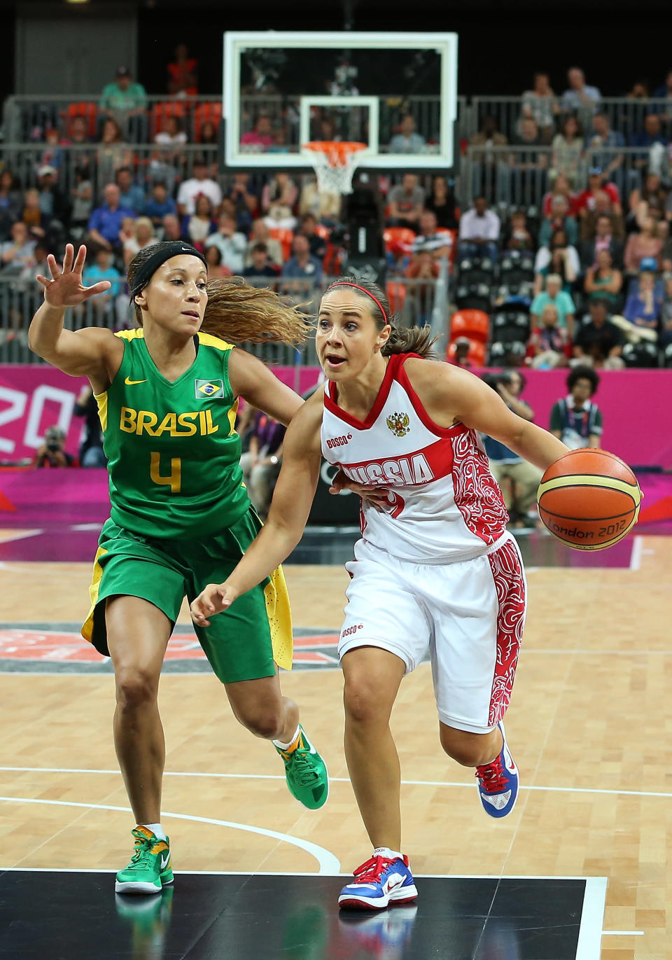 LONDON, ENGLAND - JULY 30: Becky Hammon #9 of Russia drives the ball past Adriana Pinto #4 of Brazil during the Women's Basketball Preliminary Round match on Day 3 at Basketball Arena on July 30, 2012 in London, England. (Photo by Christian Petersen/Getty Images)