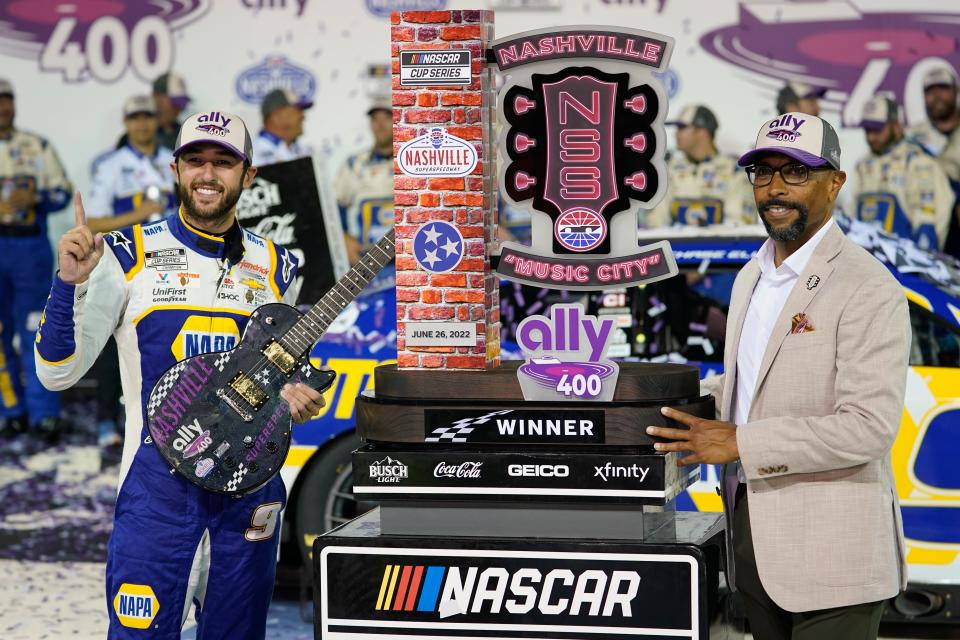Nashville Superspeedway President Erik Moses, right, presents Chase Elliott with his trophy after winning a NASCAR Cup Series auto race Sunday, June 26, 2022, in Lebanon, Tenn. (AP Photo/Mark Humphrey)