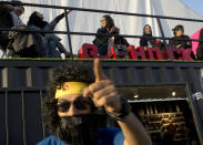 FILE - In this Friday, Feb. 17, 2017, file photo a man wearing a mask gestures during the Saudi Comic Con (SCC) which is the first event of its kind to be held in Jiddah, Saudi Arabia. The kingdom, which bans movie theaters and other entertainment venues, is challenging its ultraconservative image and loosening the reins on fun by opening its doors to live shows, including some American ones. (AP Photo)