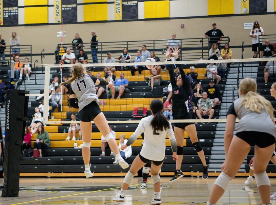 Ava Adams of Ankeny Centennial gets the attack around a block attempt earlier this season. The Jaguars are the fifth-best team in Iowa according to our midseason Super 10 rankings.