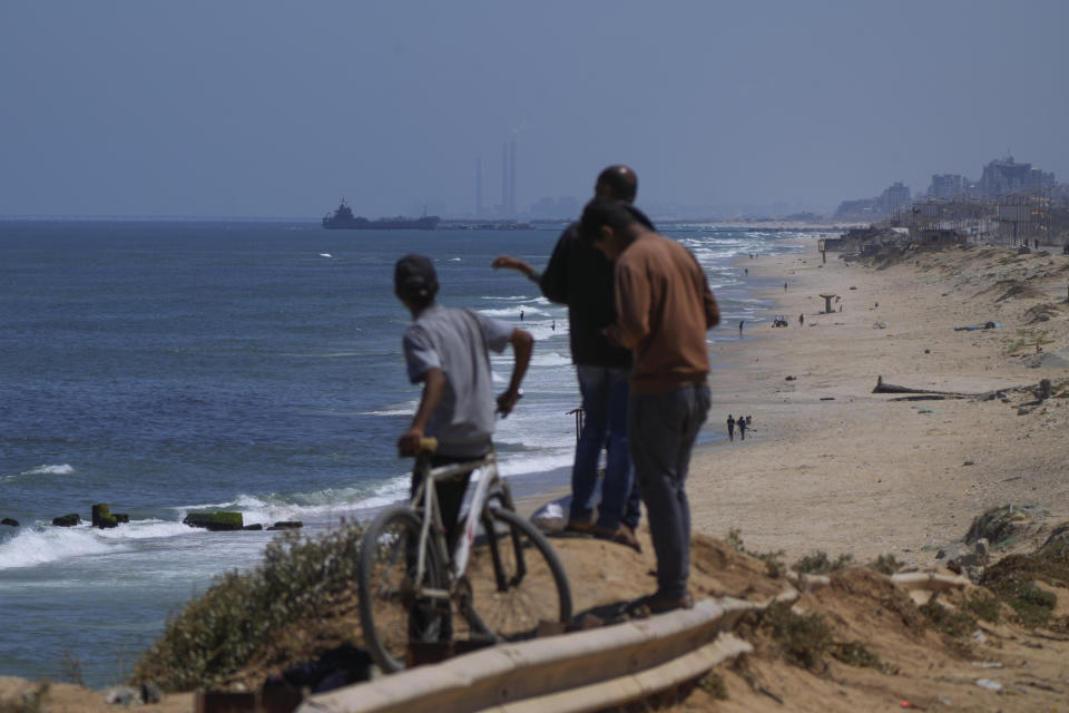 FILE - A ship is seen off the coast of Gaza near a U.S.-built floating pier that will be used to facilitate aid deliveries, as seen from the central Gaza Strip, May 16, 2024. U.S. officials said Friday, June 14, 2024, that the pier will be detached from Gaza’s coast for the second time in a month due to rough seas, raising questions about the viability of the sea route. (AP Photo/Abdel Kareem Hana, File)