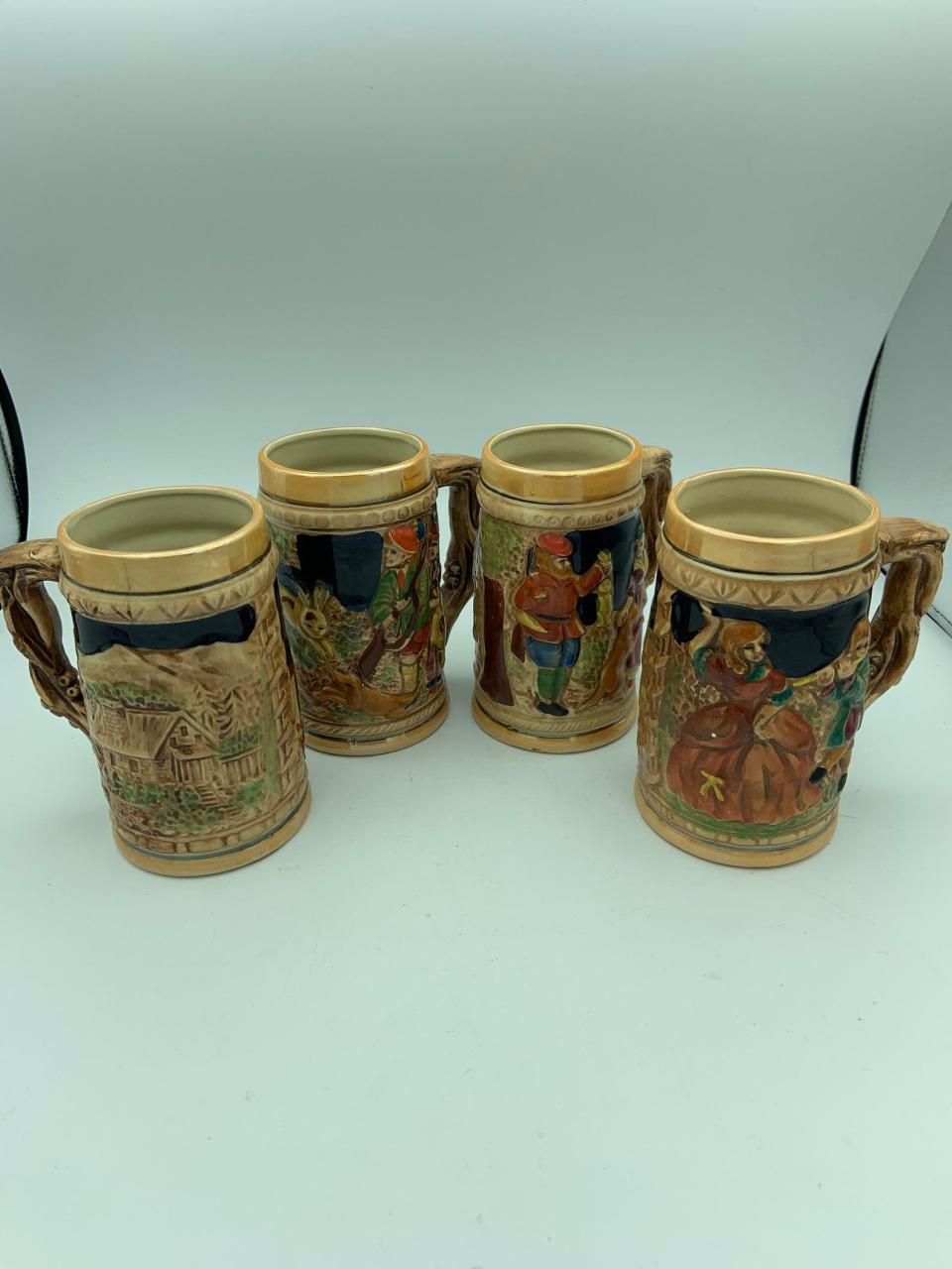 Set Of Four Vintage Ceramic Beer Steins Tankards With Embossed German Village Scenes And Tree Branch Handles Made In Japan