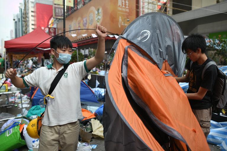 Protesters pack their belongings ahead of an expected clearance by bailiffs and police at a pro-democracy protest site in the Mongkok district of Hong Kong, on November 26, 2014