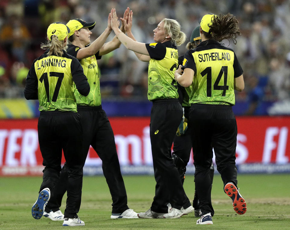 Australia's Delissa Kimmince, center, celebrates with teammates after trapping India's Jemimah Rodrigues LBW during the first game of the Women's T20 Cricket World Cup in Sydney, Friday, Feb. 21, 2020. (AP Photo/Rick Rycroft)